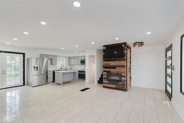 8041 Barry Rd, Indianapolis, IN 46219 - kitchen featuring stainless steel appliances, gray cabinetry, light countertops, tasteful backsplash, and recessed lighting