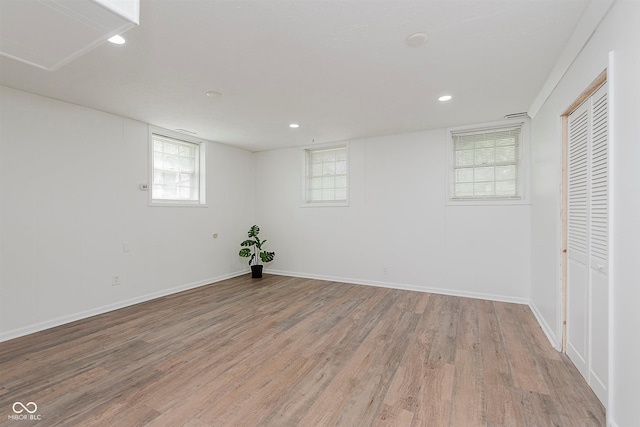 8041 Barry Rd, Indianapolis, IN 46219 - below grade area with light wood-style flooring, baseboards, recessed lighting, and plenty of natural light
