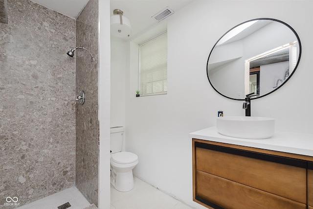 8041 Barry Rd, Indianapolis, IN 46219 - bathroom with toilet, vanity, a tile shower, and tile patterned floors