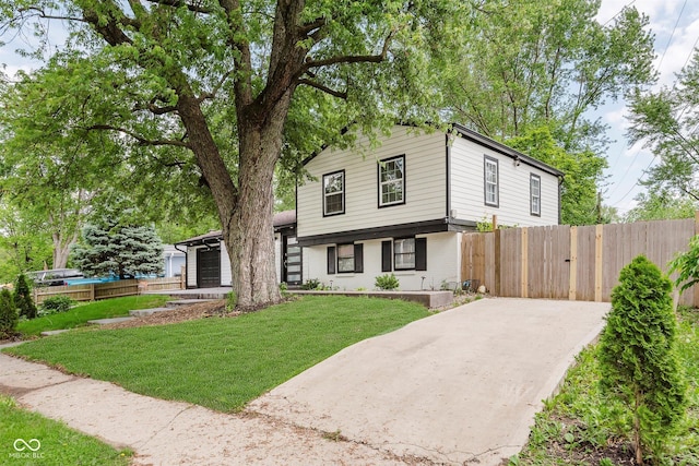 8041 Barry Rd, Indianapolis, IN 46219 - tri-level home featuring concrete driveway and brick siding