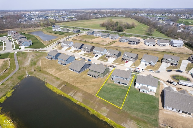 bird's eye view featuring a residential view and a water view