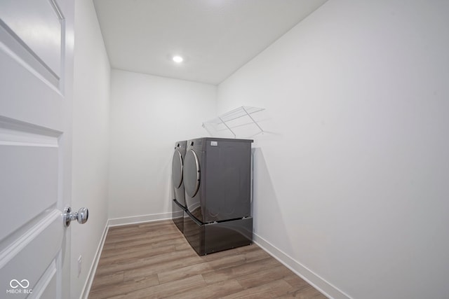 laundry room with separate washer and dryer, light wood-style floors, baseboards, laundry area, and recessed lighting