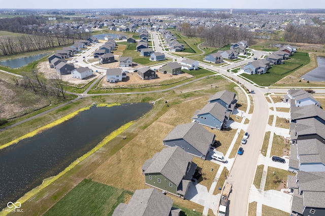 bird's eye view featuring a water view and a residential view
