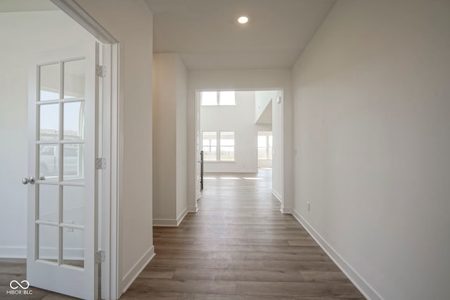 corridor featuring baseboards, recessed lighting, and dark wood-type flooring