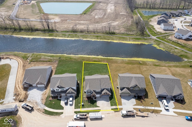 drone / aerial view featuring a water view and a residential view