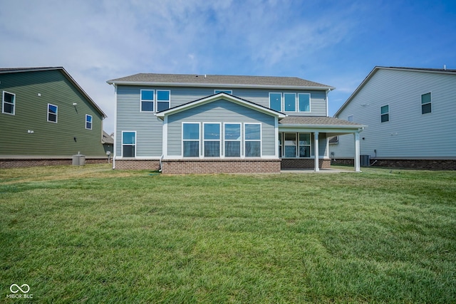 back of house with a lawn, central AC unit, and brick siding