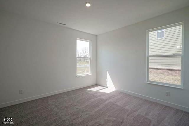 carpeted spare room with baseboards, visible vents, and recessed lighting
