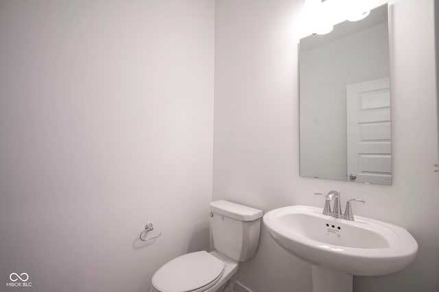 bathroom with toilet and a sink