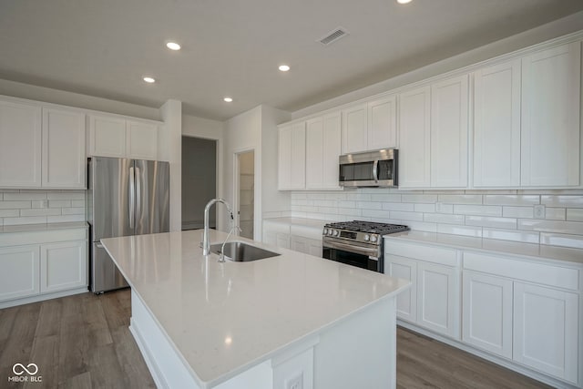 kitchen with appliances with stainless steel finishes, a sink, visible vents, and recessed lighting