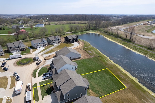 drone / aerial view featuring a residential view and a water view