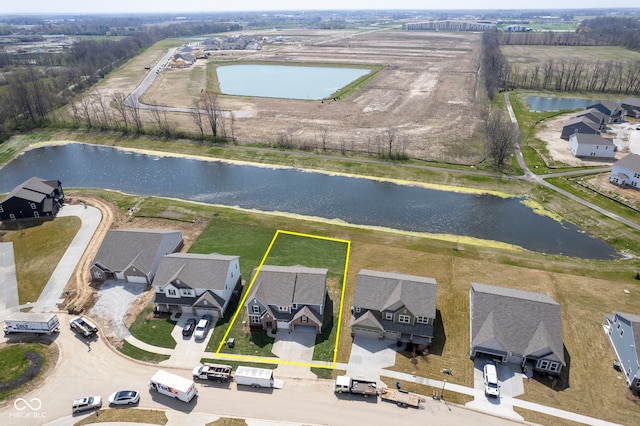 drone / aerial view with a residential view and a water view