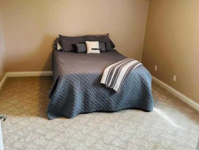 bedroom featuring baseboards and carpet