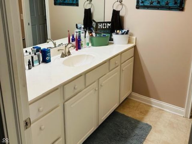bathroom with baseboards and vanity