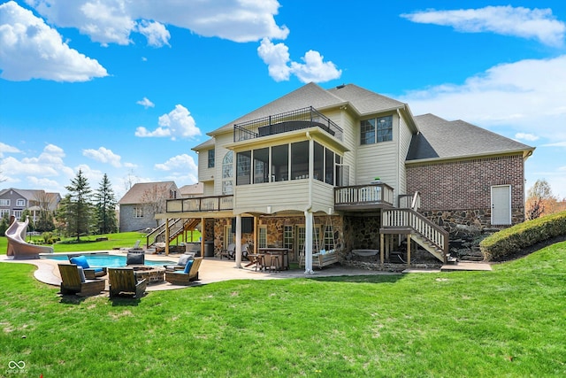 back of house with a wooden deck, a patio area, a balcony, stairs, and stone siding