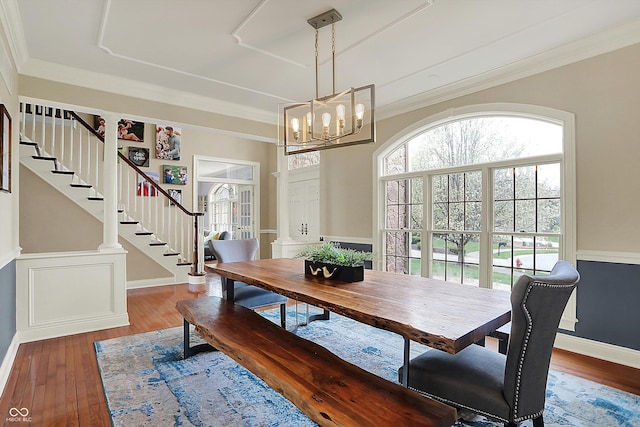 dining space with stairway, baseboards, hardwood / wood-style floors, and a notable chandelier
