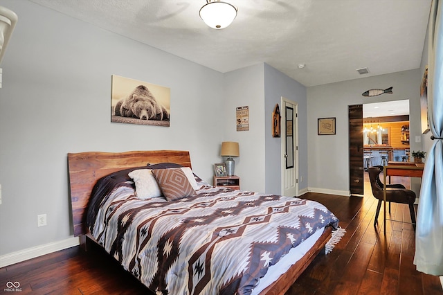 bedroom featuring wood-type flooring, baseboards, and visible vents