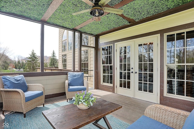 sunroom with a ceiling fan, a wealth of natural light, and french doors