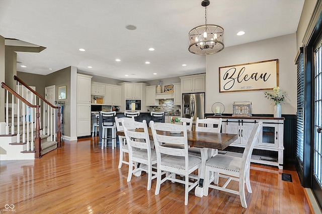 dining space featuring an inviting chandelier, visible vents, stairway, recessed lighting, and light wood-style flooring