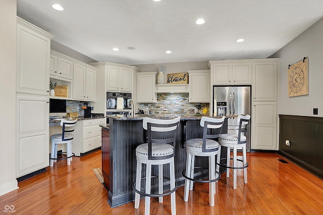 kitchen featuring a kitchen island, backsplash, and white cabinets