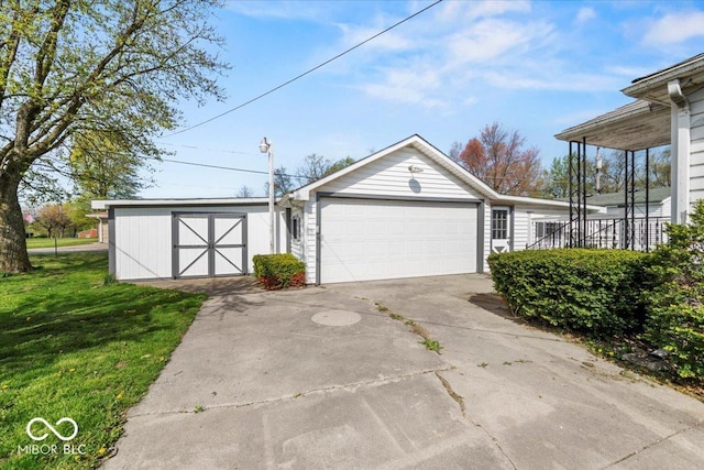 garage featuring a storage unit and concrete driveway