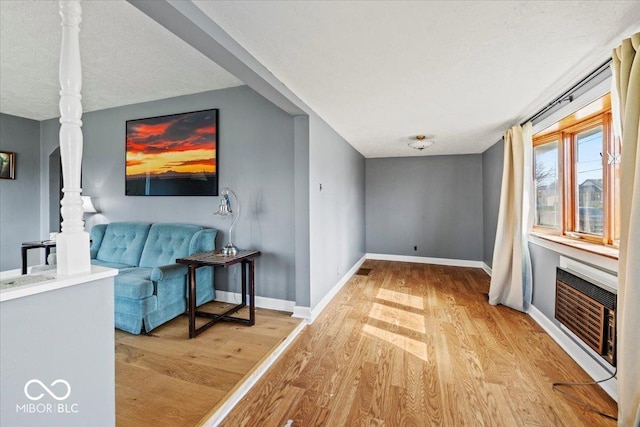 living room featuring baseboards and wood finished floors