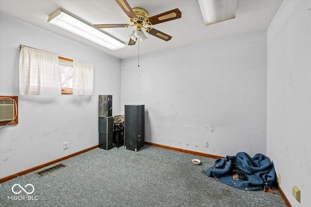 spare room featuring a ceiling fan, carpet flooring, baseboards, and visible vents