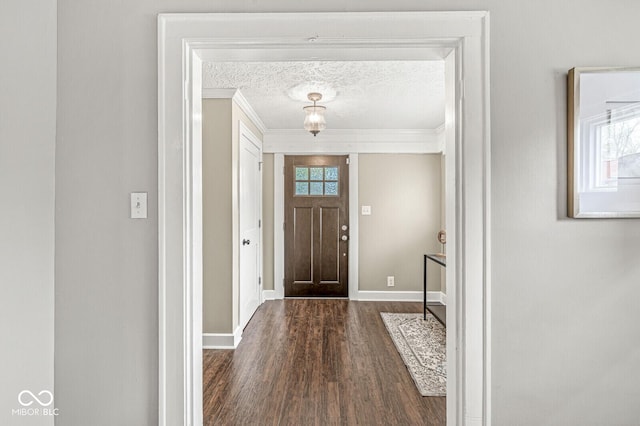 foyer entrance with crown molding, plenty of natural light, and dark wood-style floors