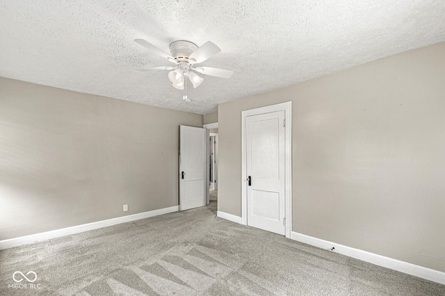 unfurnished bedroom with baseboards, a textured ceiling, carpet floors, and ceiling fan