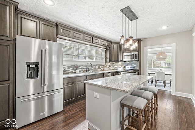 kitchen featuring a sink, dark wood-style floors, dark brown cabinets, and stainless steel appliances