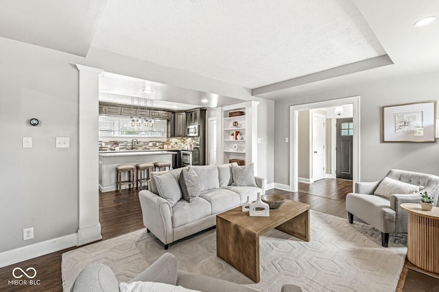 living area with baseboards, recessed lighting, and wood finished floors