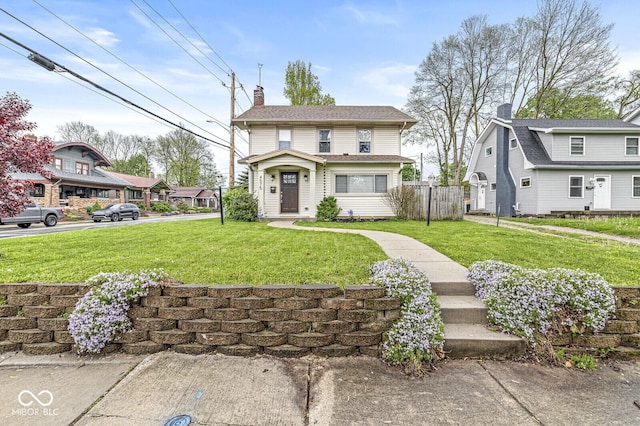 view of front of house with a front lawn, fence, and a chimney