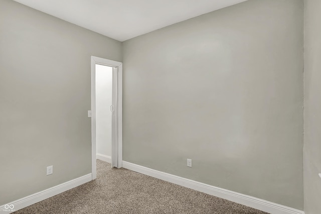 734 N Bradley Ave, Indianapolis, IN 46201 - spare room with baseboards and light carpet