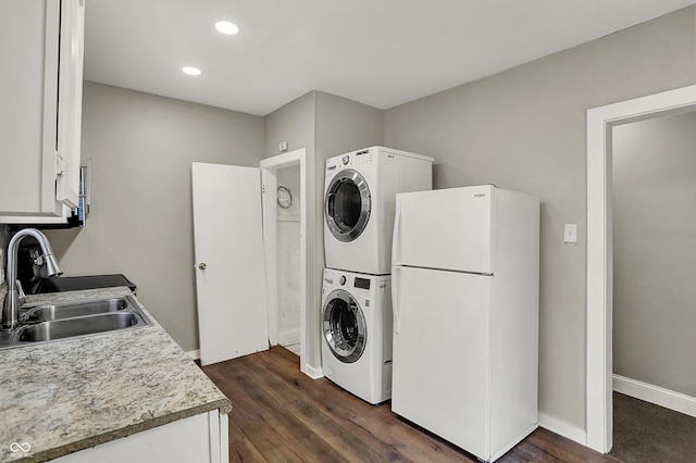 734 N Bradley Ave, Indianapolis, IN 46201 - laundry area featuring recessed lighting, baseboards, a sink, dark wood-type flooring, and stacked washer / drying machine