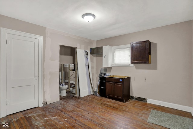 734 N Bradley Ave, Indianapolis, IN 46201 - unfurnished bedroom with baseboards and hardwood / wood-style flooring