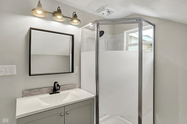 734 N Bradley Ave, Indianapolis, IN 46201 - full bathroom featuring vanity, vaulted ceiling, and a stall shower