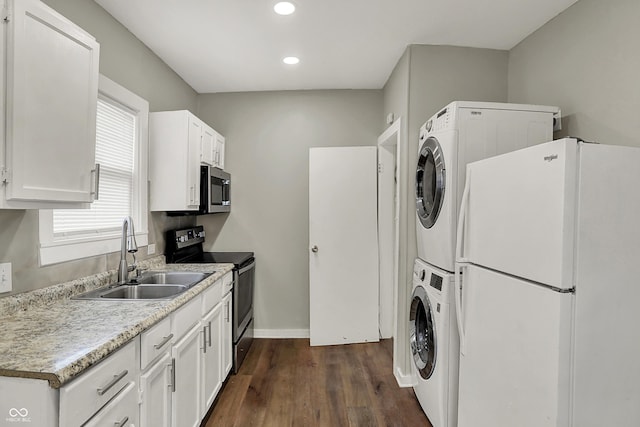 734 N Bradley Ave, Indianapolis, IN 46201 - kitchen with a sink, stainless steel appliances, stacked washer / dryer, recessed lighting, and dark wood-style floors