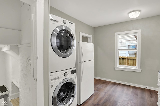 734 N Bradley Ave, Indianapolis, IN 46201 - clothes washing area featuring baseboards, visible vents, stacked washer and dryer, wood finished floors, and laundry area