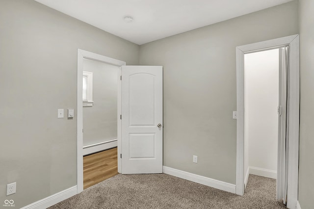 734 N Bradley Ave, Indianapolis, IN 46201 - unfurnished bedroom featuring carpet, baseboards, and a baseboard heating unit