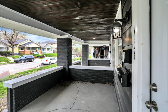 734 N Bradley Ave, Indianapolis, IN 46201 - view of patio featuring covered porch and a residential view