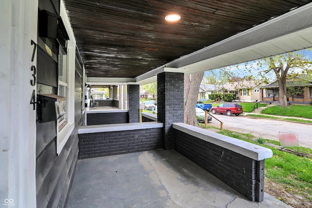 734 N Bradley Ave, Indianapolis, IN 46201 - view of patio featuring a porch and a residential view