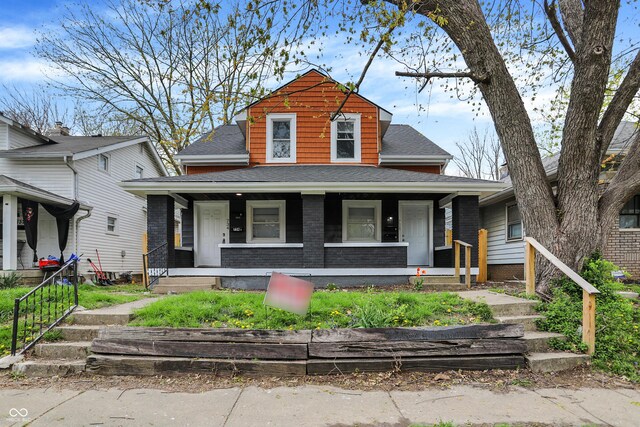 734 N Bradley Ave, Indianapolis, IN 46201 - view of front facade with covered porch and a shingled roof
