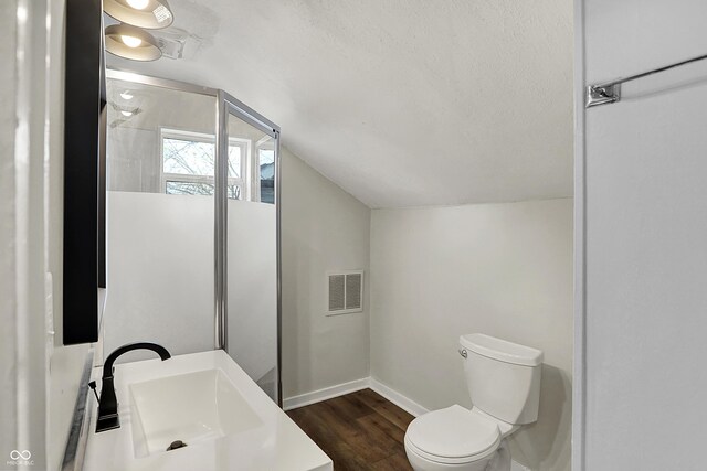 734 N Bradley Ave, Indianapolis, IN 46201 - bathroom featuring toilet, wood finished floors, visible vents, baseboards, and lofted ceiling
