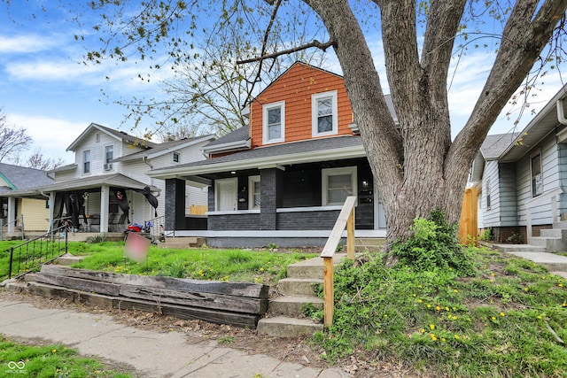 734 N Bradley Ave, Indianapolis, IN 46201 - view of front facade with covered porch and a shingled roof
