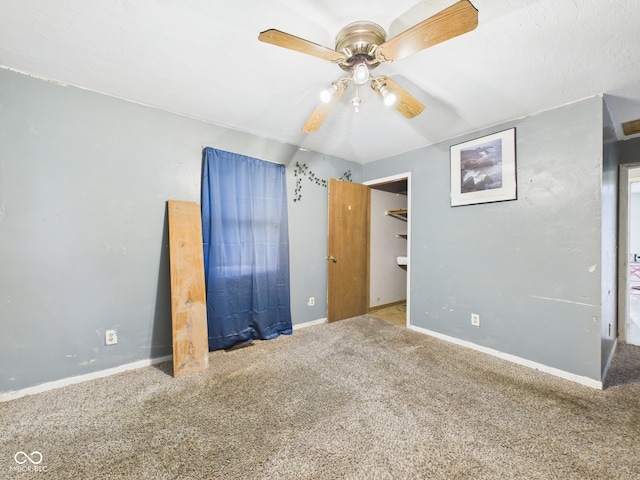 unfurnished bedroom featuring carpet flooring, baseboards, and ceiling fan