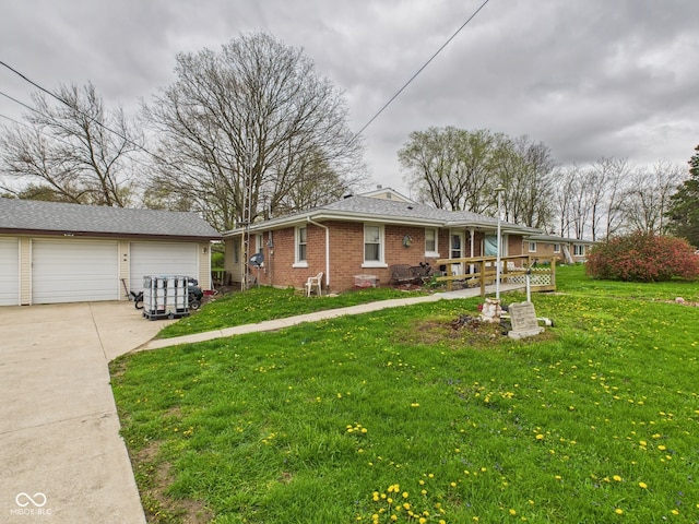 single story home with a front lawn, brick siding, an outdoor structure, and a garage