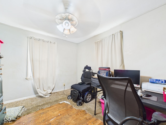 office space with wood finished floors, baseboards, and ceiling fan