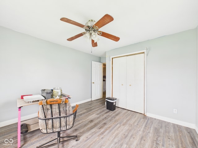 home office with wood finished floors, baseboards, and ceiling fan