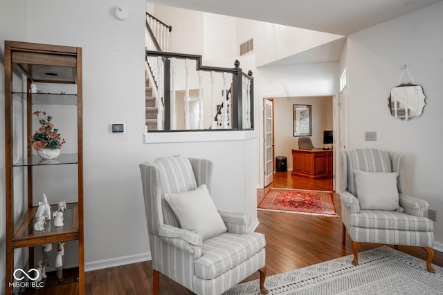 sitting room featuring baseboards, visible vents, and wood finished floors