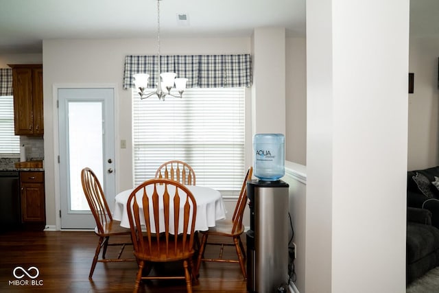 dining room featuring an inviting chandelier and dark wood-type flooring