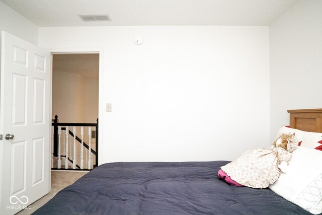 carpeted bedroom with visible vents